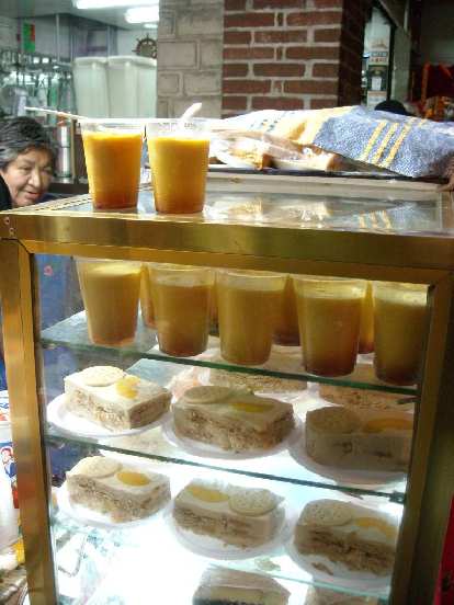 Deserts from another street vendor.  We had the flan (top), and another day tried the pastries that were like cake with a cookie on top (on the bottom shelves in the photo).