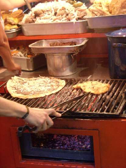 A street vendor in Oaxaca grilling a tlayuda.
