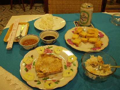 Grilled fish, steamed rice, fried tofu, and Huda beer in Hue.
