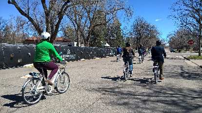 Ceremonial parade after the unveiling of the Fort Collins Bike Share program. woman in green jersey riding white Zagster bicycle, other cyclists
