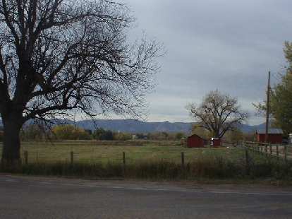 Red barns in front of the Front Range.