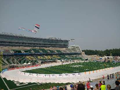 A skydiver bringing in the American flag to the stadium in the post-race activities. A skydiver bringing in the American flag to the stadium in the post-race activities.