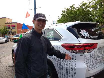 Felix Wong with a Toyota Highlander wrapped with the list of all participants' names in the 2017 Grandma's Marathon. Felix Wong with a Toyota Highlander wrapped with the list of all participants' names in the 2017 Grandma's Marathon.