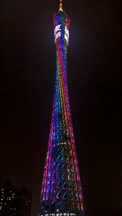 The Canton Tower lighted up at night as seen from a cruise ship on the Zhujiang River.