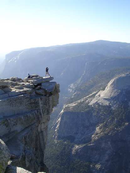 On the "diving board" just across from the top of Half Dome was a young couple shooting photos and taking in the view. On the "diving board" just across from the top of Half Dome was a young couple shooting photos and taking in the view.