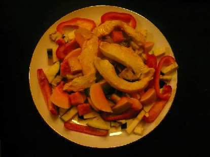A stir fry of red bell peppers, eggplant, butternut squash, and chicken.