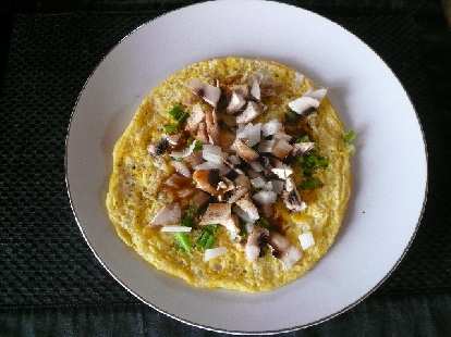 Two eggs with white onions, green bell peppers, and mushrooms.