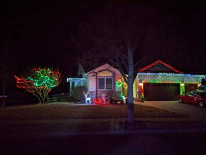 A home in the Hearthfire subdivision with red and green Christmas lights.