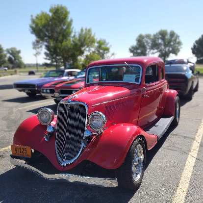 A red Ford deuce coupe hot rod.