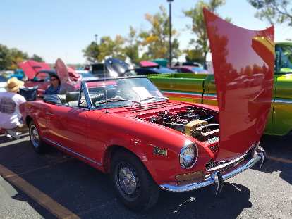 A red 1970s Fiat 124 Spider.