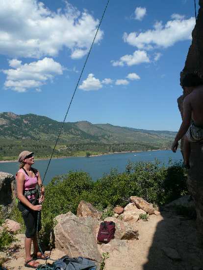 Anita belaying at Rotary Park with the Horsetooth Reservoir behind.