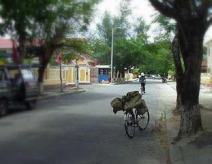 Bicycle and cyclist in Hue.