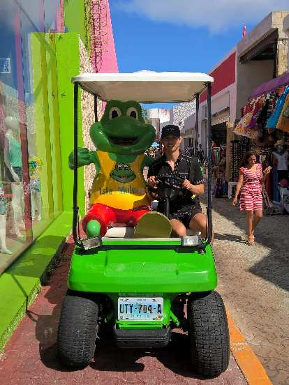 Felix Wong with Señor Frog in a green golf cart at Isla Mujeres. Felix Wong, Señor Frog, golf cart, Isla Mujeres