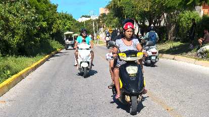 Mexicans driving motorbikes in Isla Mujeres. Mexicans driving motorbikes in Isla Mujeres.