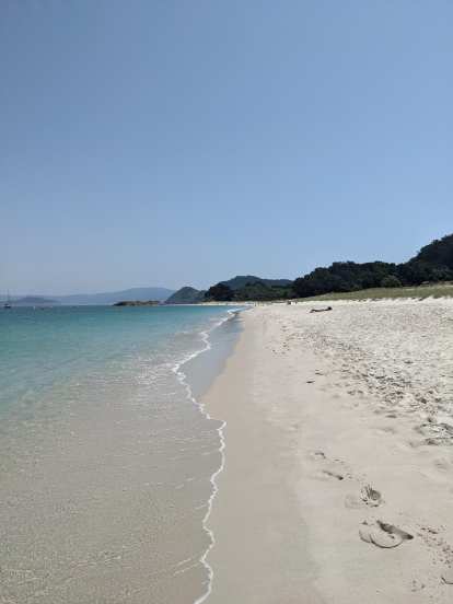 The clear waters and clean sand of Rodas Beach.