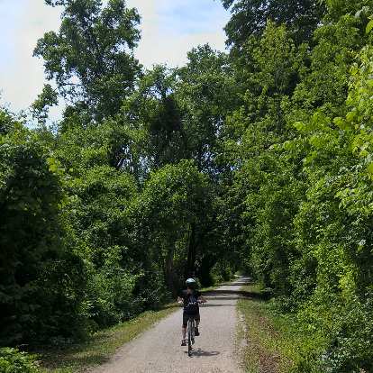 Maureen riding southwest on the Katy Trail a few miles from St. Charles.