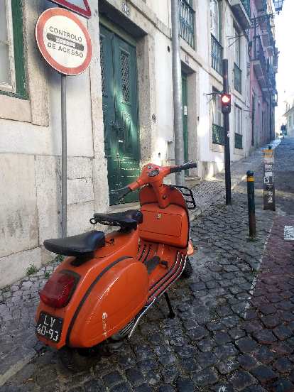 A vintage orange motorbike in Lisbon, Portugal.