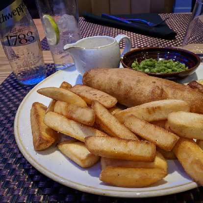 Fish and chips, peas, and tonic water at Roba Bar & Restaurant in London.