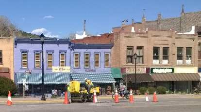 Downtown Manitou Springs, construction, motorcycle with adult and child