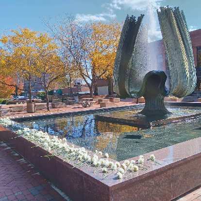 Runners placed white flowers at Memorial Fountain during the Marshall University Marathon.