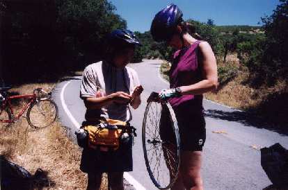 Oh no. One mile from our destination, Memorial Park, Loren gets a flat. Here we are trying to repair the torn rim tape with... bandages! Oh no. One mile from our destination, Memorial Park, Loren gets a flat. Here we are trying to repair the torn rim tape with... bandages!