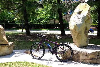 Dan's purple Surly in front of some stone art on the West Riverfront Parkway.