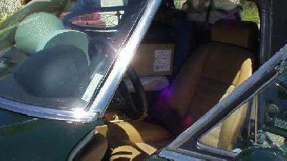 The Alfa Romeo Spider was so stuffed with boxes that it was hard to shift into 4th gear, so I would shift from 3rd to 5th... (25 Jul 2005) moving boxes inside green 1991 Alfa Romeo Spider interior
