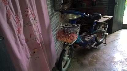 The villager had an old motorbike.