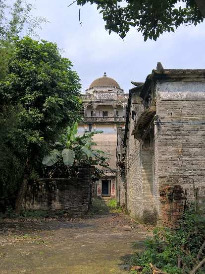 View of a neighboring five-story house with domed roof. View of a neighboring five-story house with domed roof.
