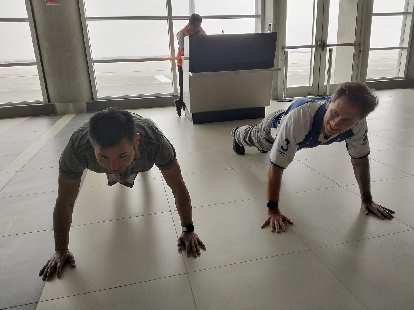Felix and Matthew doing push-ups inside the Pisco Airport.