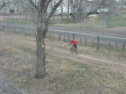 Lone mountain biker on a flat stretch.