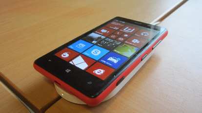 My Nokia Lumia 820 with a new red Qi charging cover on top of a white Nokia DT-900 charging pad.