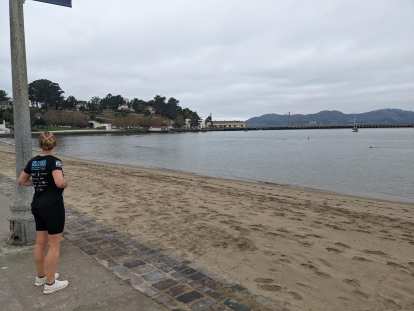 Andrea looking at the Golden Gate Bridge from Aquatic Park Cove and 757 Beach in San Francisco.