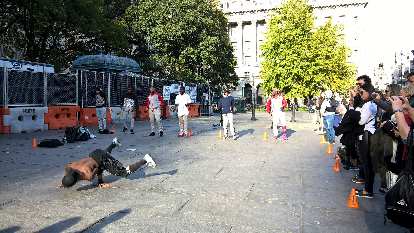 Street performers in a plaza near the west end of the Brooklyn Bridge.
