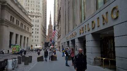 The Trump Building on 40 Wall St., with Trinity Church in the background.