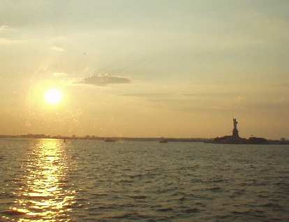 The view of the Statue of Liberty from the ferry, as lit by a dawning sun. The view of the Statue of Liberty from the ferry, as lit by a dawning sun.