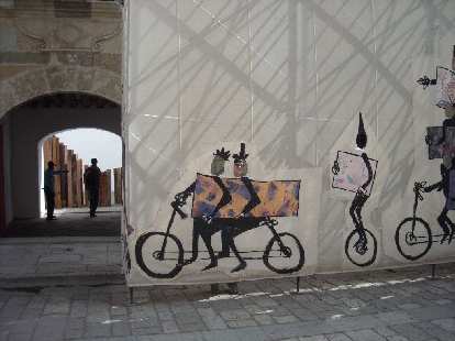 Sarah sticking her face in the hole of some bicycle art. Sarah sticking her face in the hole of some bicycle art.