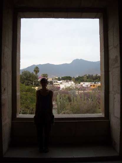 Sarah inside the museum at La Iglesia de Santo Domingo, with the Botanical Gardens (and mountain views) outside.