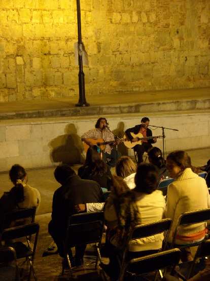 Two guys on acoustic guitars outside the Instituto de Artes Graficas in Oaxaca de Juarez.