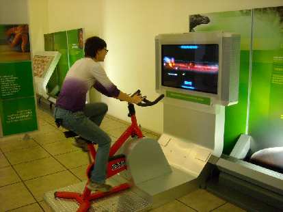 Sarah on an interactive exhibit that required pedaling to slow or speed up the display of words on the screen.