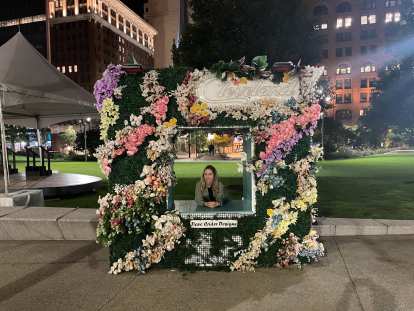 Andrea in a Dave Crider Designs flower-covered vertical square in downtown Cleveland.