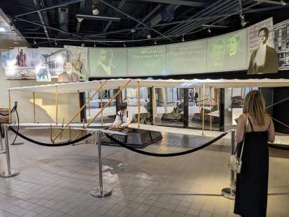 Andrea with a replica of the Wright Brothers' 1902 airplane at Dayton Aviation Heritage National Historical Park in Dayton, Ohio.