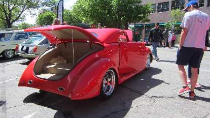 A red, chopped, hot rod coupe with suicide doors. red chopped hot rod coupe with suicide doors