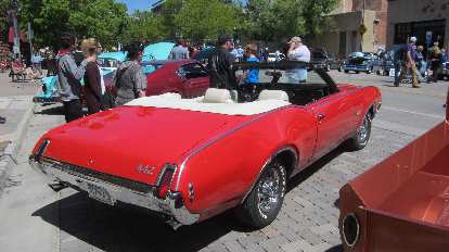 A red Oldsmobile 442 convertible. red Oldsmobile 442 convertible