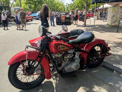 A vintage Indian motorcycle with sidecar.