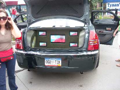 A Chrysler 300C with numerous flat-panel TVs inside the car and in the trunk.