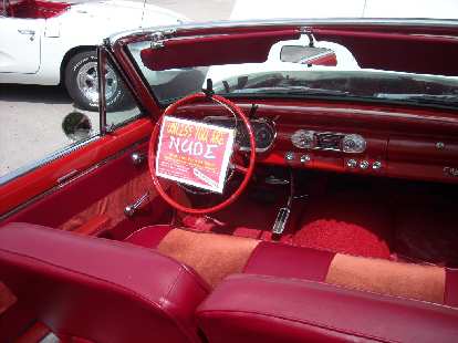 The interior of a Chevy Nova convertible.  "Don't touch unless you are NUDE" proclaimed the sign.