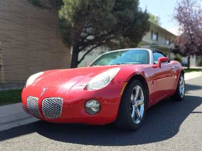 A nice red Pontiac Solstice roadster.