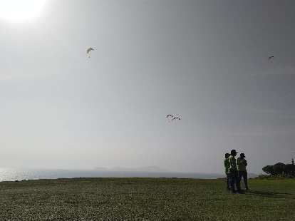 The sun shining brightly on the paragliders of Lima, Peru.