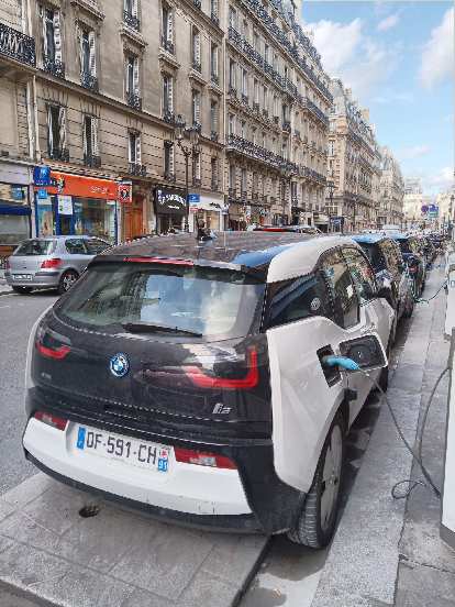 Electric vehicles charging along a street in Paris. BMW i3 in Paris